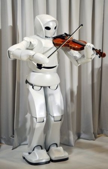 Toyota Motor Corp.'s new violin robot performs during a media unveiling in Tokyo Thursday. (THE ASSOCIATED PRESS/Katsumi Kasahara)