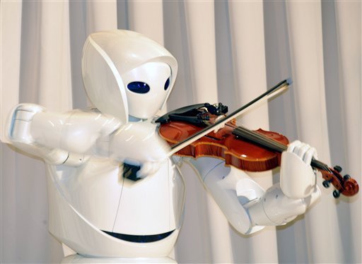 Toyota Motor Corp.'s new violin robot performs during a media unveiling in Tokyo Thursday. (THE ASSOCIATED PRESS/Katsumi Kasahara)