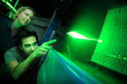 Two of the team members watch the artificial shark skin within a water tunnel to study its fluid dynamics (Image: Amy Lang, University of Alabama)