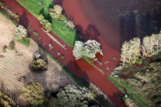 A handout picture released by Greenpeace on 08 October 2010 shows an aerial view of the toxic Hungarian flood, covering fields, streets and canals. The toxic Hungarian sludge flood was caused by the rupture of a red sludge reservoir at an alumina plant in western Hungary and has affected seven towns near Ajkai, 160 km southwest of Budapest, Hungary. The flood of toxic is responsible for six missing people and 120 are injured. This sludge is highly toxic and contains a mixture of heavy metals.  EPA/PETER SOMOGYI-TOTH - HANDOUT