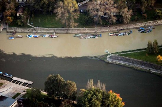 A handout picture released by Greenpeace on 08 October 2010 shows an aerial view of the toxic Hungarian flood, running into the nearest rivers Raba and Marcal. The toxic Hungarian sludge flood was caused by the rupture of a red sludge reservoir at an alumina plant in western Hungary and has affected seven towns near Ajkai, 160 km southwest of Budapest, Hungary. The flood of toxic is responsible for six missing people and 120 are injured. This sludge is highly toxic and contains a mixture of heavy metals.  EPA/PETER SOMOGYI-TOTH - HANDOUT