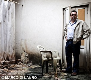 Geophysicist Renato Somma at an abandoned building destroyed by sulphurous deposits from the caldera