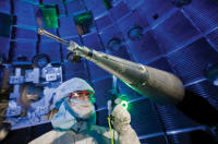 A positioner precisely centers the target inside the target chamber and serves as a reference to align the laser beams